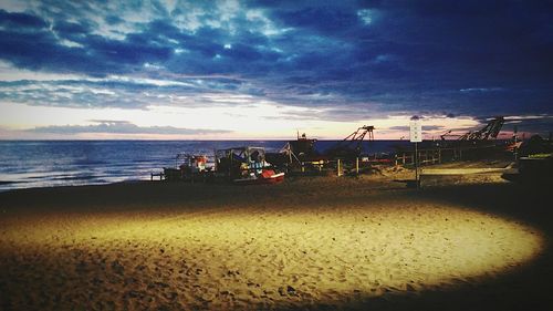 View of calm beach against scenic sky