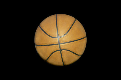 Close-up of basketball hoop against black background