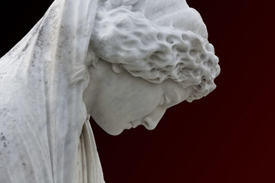 Close-up of white statue against black background