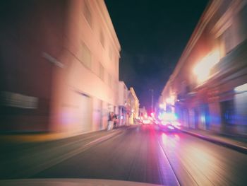 Illuminated road in city at night