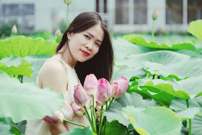 Portrait of young woman holding flower