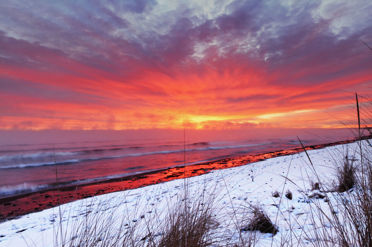 sunset, nature, beauty in nature, sky, scenics, orange color, cloud - sky, snow, cold temperature, tranquil scene, winter, outdoors, tranquility, no people, water, dramatic sky, landscape, agriculture, beach, day