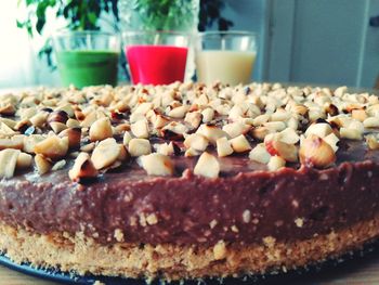 Close-up of cake garnished with nuts on table