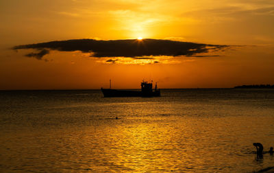 Scenic view of sea against orange sky