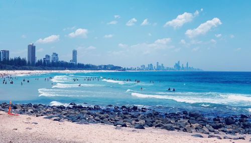 Panoramic view of sea and buildings against sky