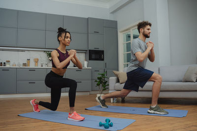 Full length of woman exercising in gym