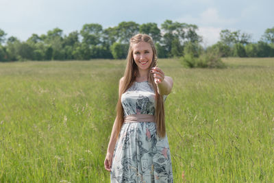 Portrait of young woman in grass