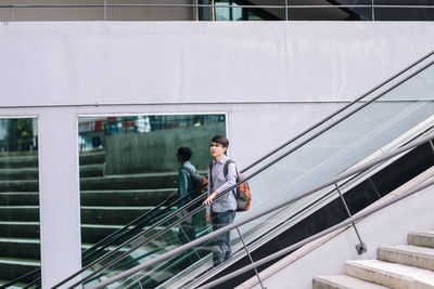 Man standing on escalator