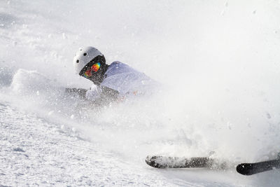 Portrait of young man skiing on snow