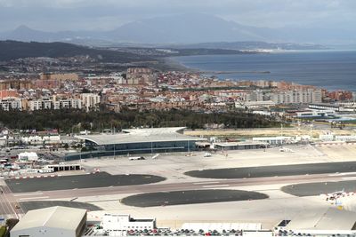 High angle view of townscape by sea against sky