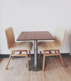 Empty chairs and table at restaurant