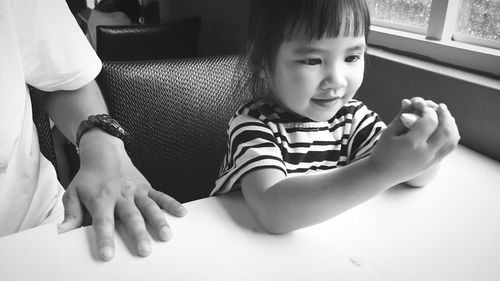 High angle view of girl sitting at home