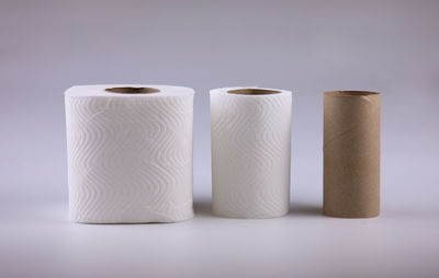 Close-up of candles on table against white background