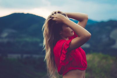 Woman standing against mountains