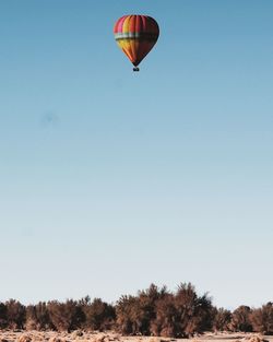 Low angle view of hot air balloon against clear blue sky