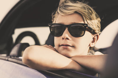 Portrait of man wearing sunglasses in car