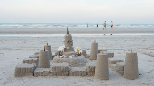 People on beach against sky