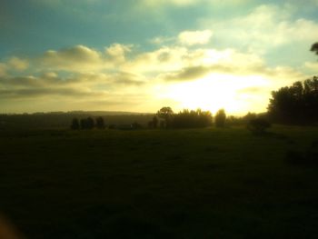 Scenic view of field against sky during sunset