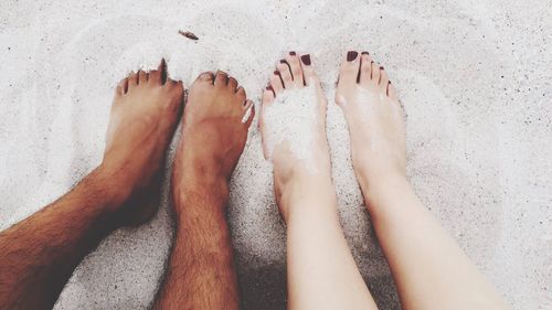 Couple's low section on beach