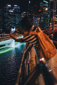 Low angle view of woman standing in city