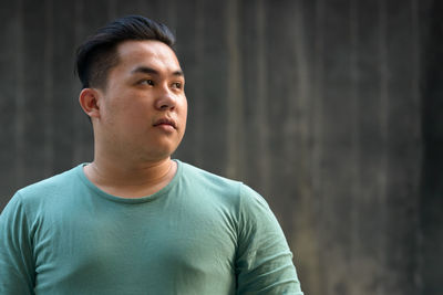 Young man looking away outdoors