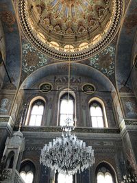 Low angle view of chandelier hanging from ceiling in cathedral