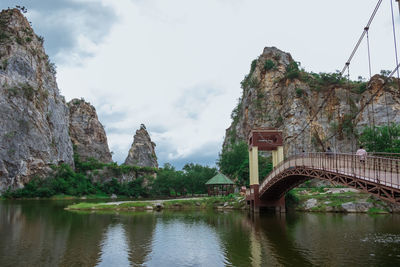 Arch bridge over river against sky