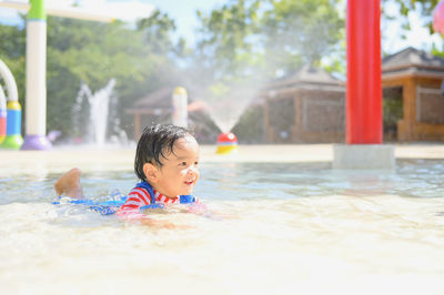 Portrait of boy swimming in pool