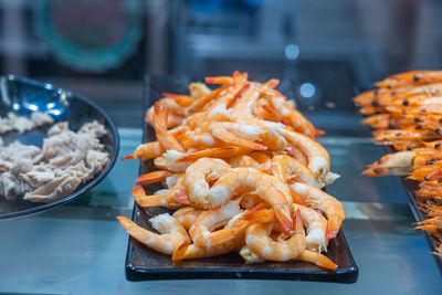 Fresh cooked and peeled shrimps on the plate in kitchen