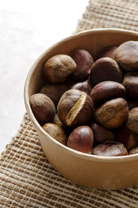 Front view of autumn chestnuts on jute fabric background