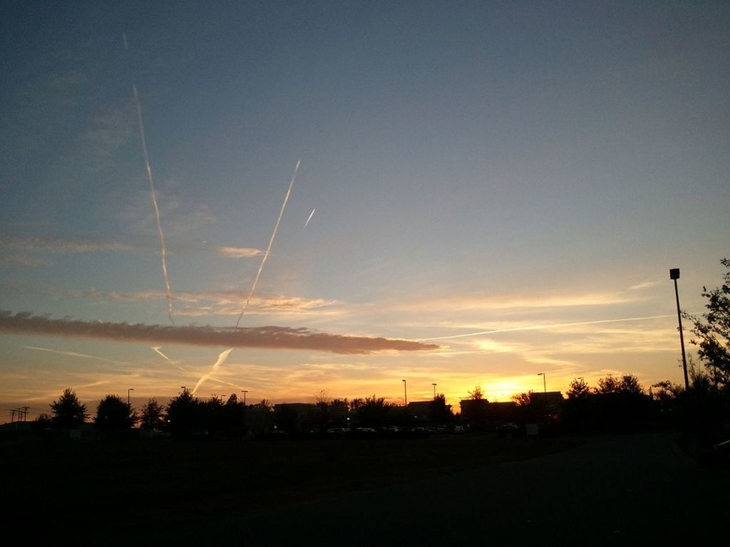 sunset, silhouette, transportation, sky, road, landscape, electricity pylon, dusk, scenics, built structure, outdoors, tranquility, nature, tranquil scene, street, orange color, tree, car, beauty in nature, mode of transport