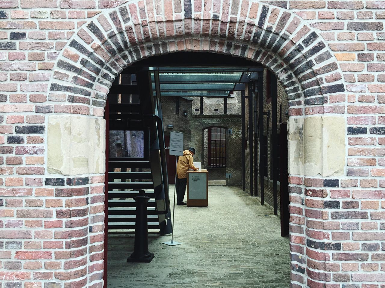 built structure, architecture, brick wall, men, building exterior, house, doorway, door, day, entrance, person, archway, outdoors, freshness, arched