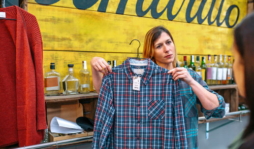 Portrait of young woman standing in store