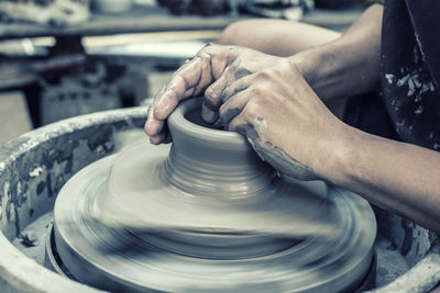 High angle view of woman working on pottery wheel