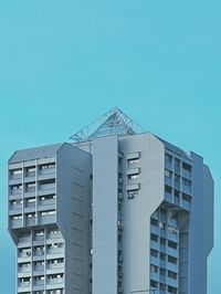 Low angle view of modern building against clear blue sky