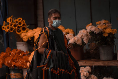 Full length of man holding flowers