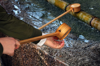 Cropped hand of man performing traditional ritual in temple