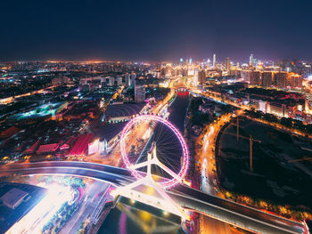 High angle view of illuminated city street and buildings at night