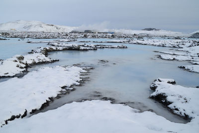 Scenic view of frozen lake against sky