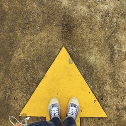 Low section of person standing on road