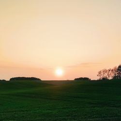 Scenic view of field against sky during sunset