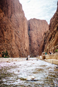 People on mountain against sky