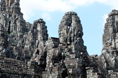 Low angle view of rock formation against sky