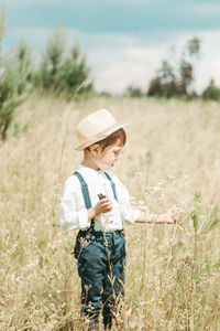 Rear view of boy standing on field