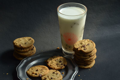 High angle view of chocolate chip cookies with milk