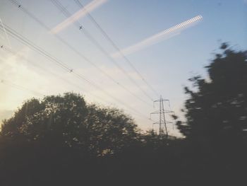 Low angle view of electricity pylon against sky