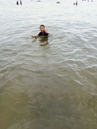 Portrait of young woman swimming in lake