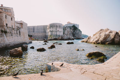 Scenic view of sea and castle against clear sky