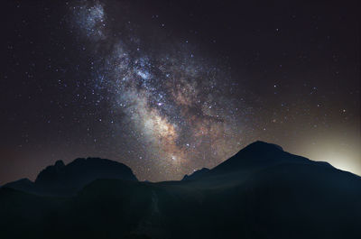 Low angle view of sky over mountains at night