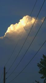 Low angle view of power lines against sky